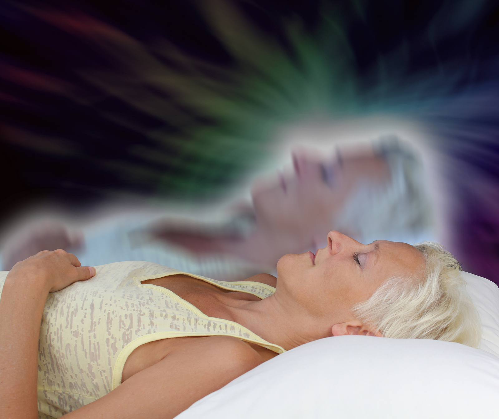 Female lying supine with eyes closed experiencing astral projection on dark background showing soul leaving body